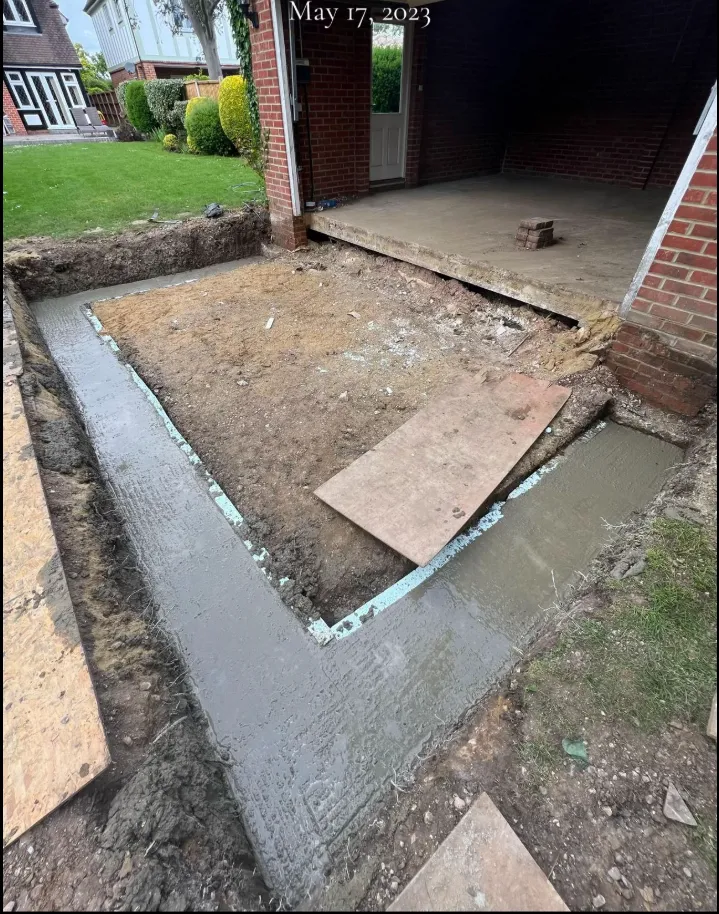 Concrete strip foundations beside a residential property
